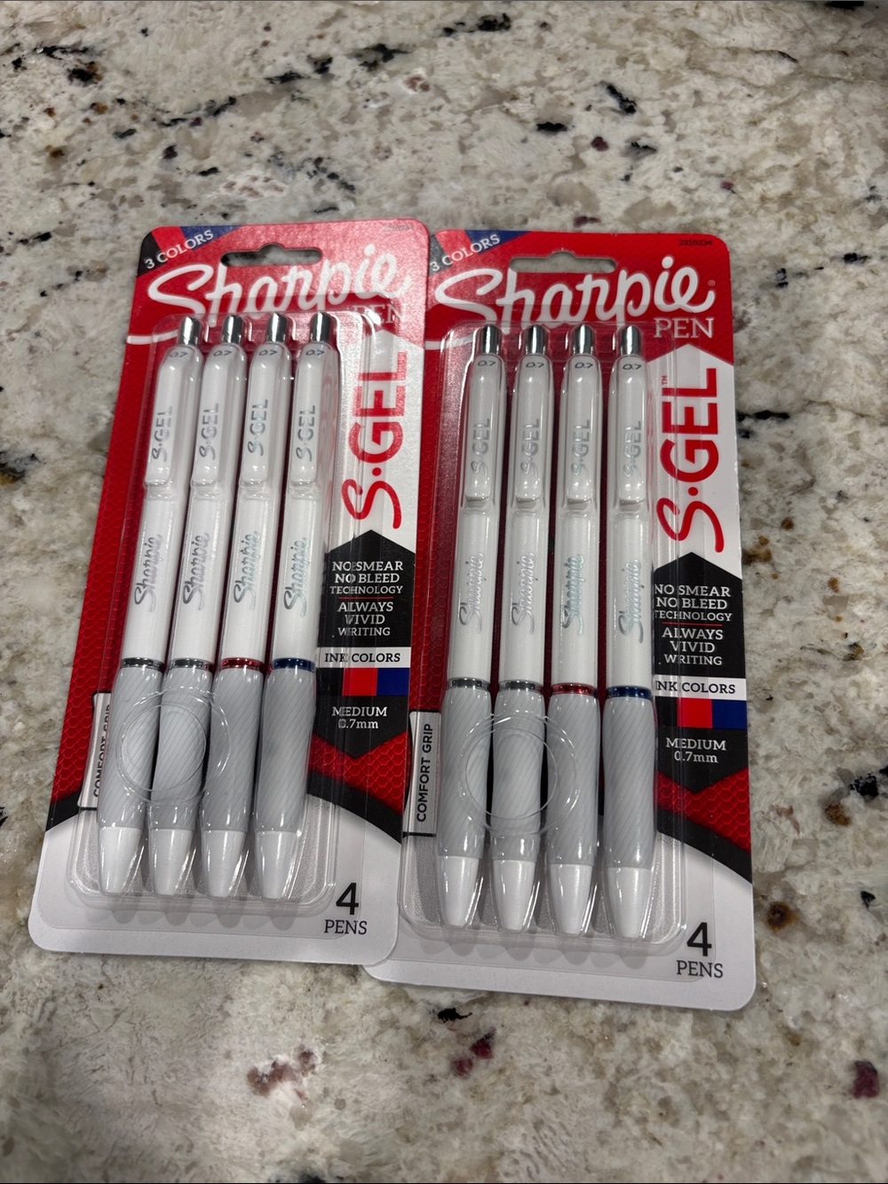 Brand new never opened packs of sharpie pens. Two black, a red & blue in each.